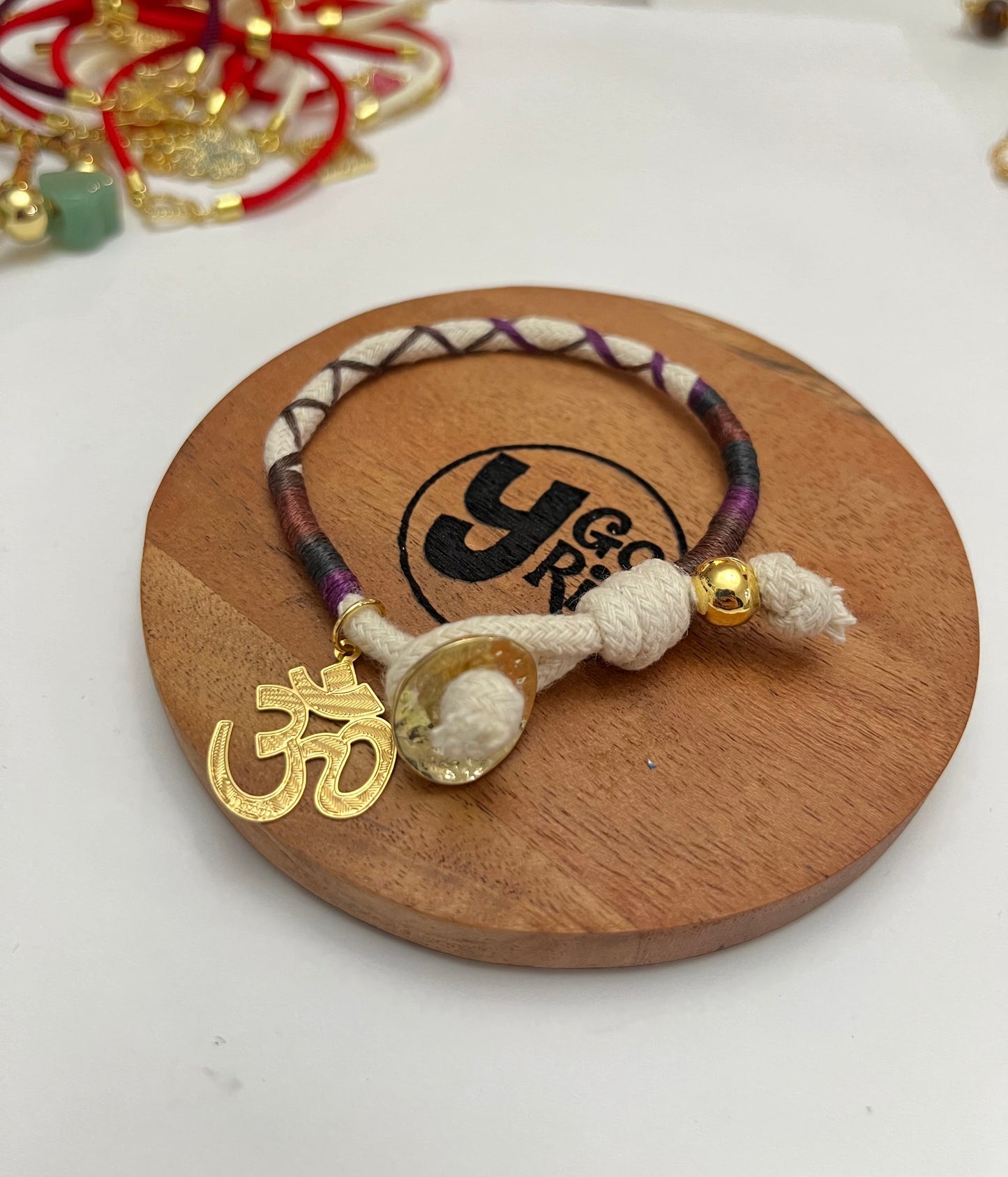 White cord bracelet with OM symbol