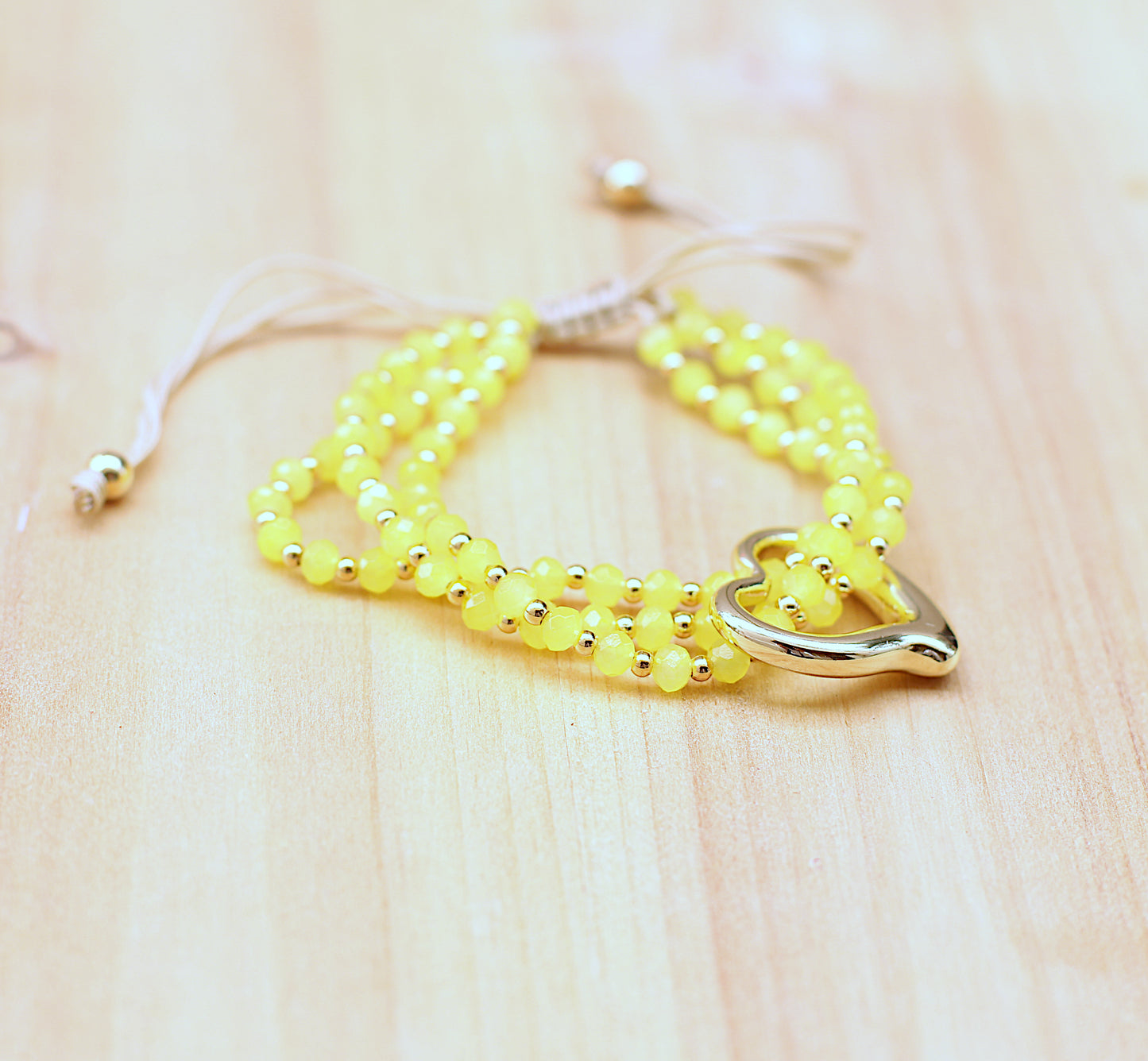 Three-strand beaded yellow bracelet with heart