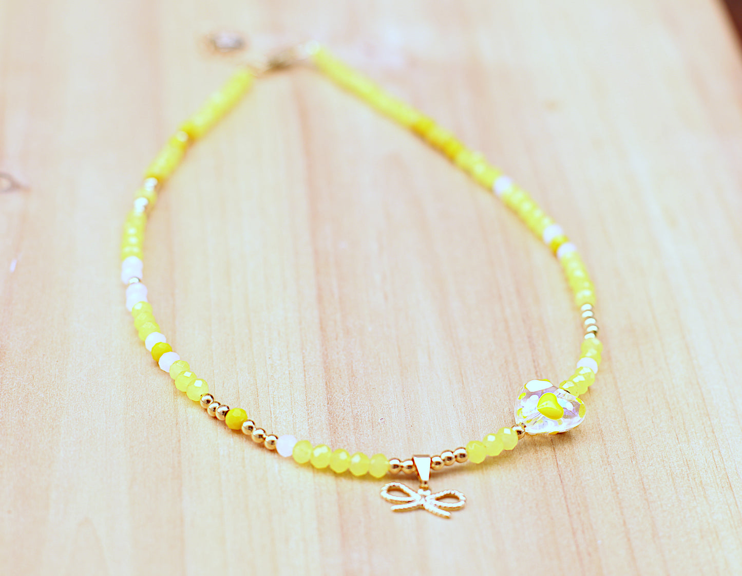 Yellow glass beads necklace with heart and bow charm