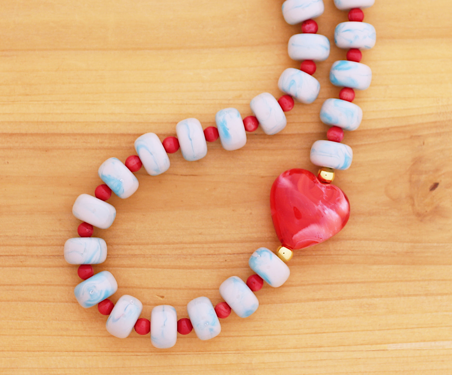Blue marbleized donut shape beads with red heart necklace