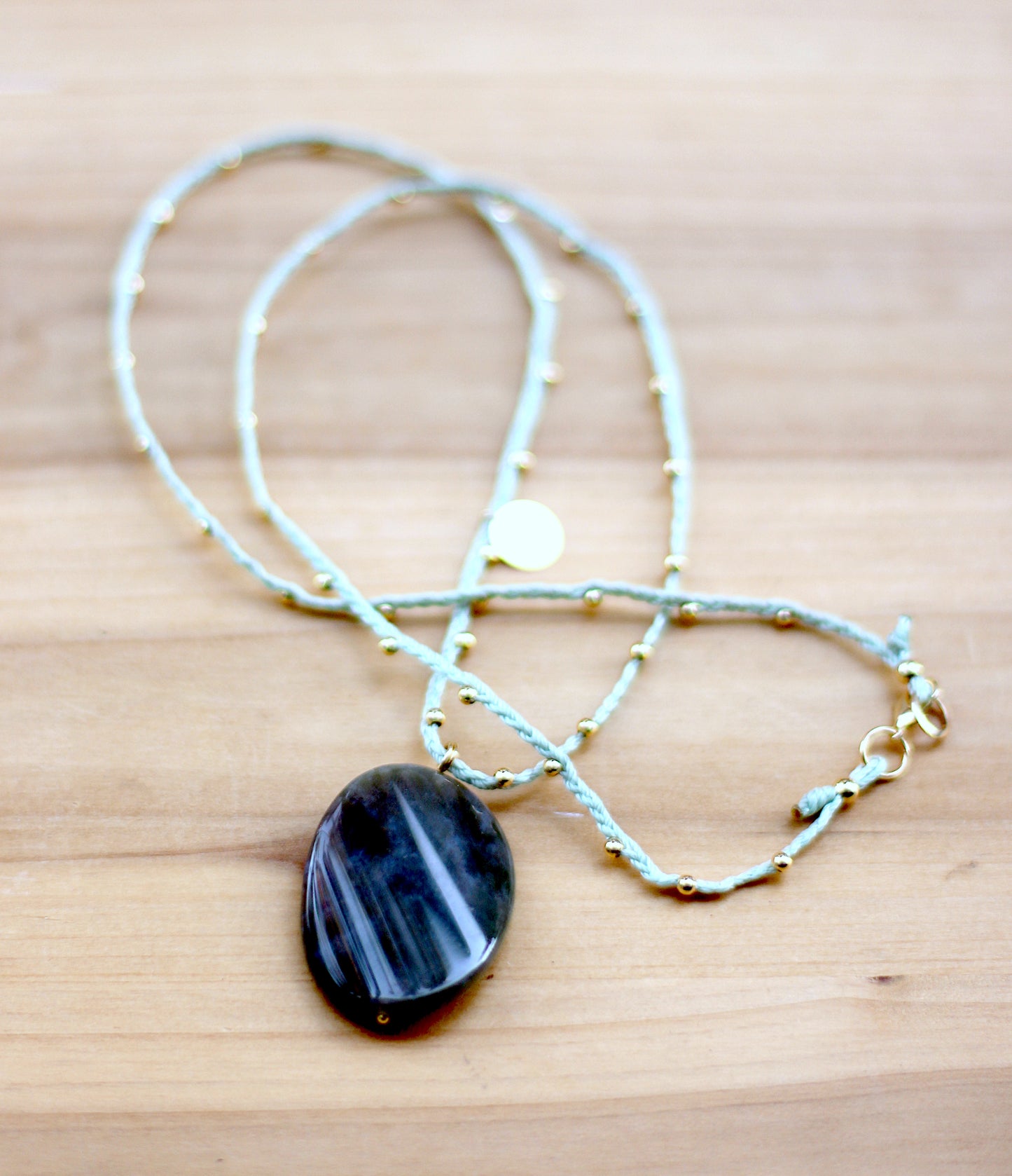 Green necklace with nephrite oval stone.