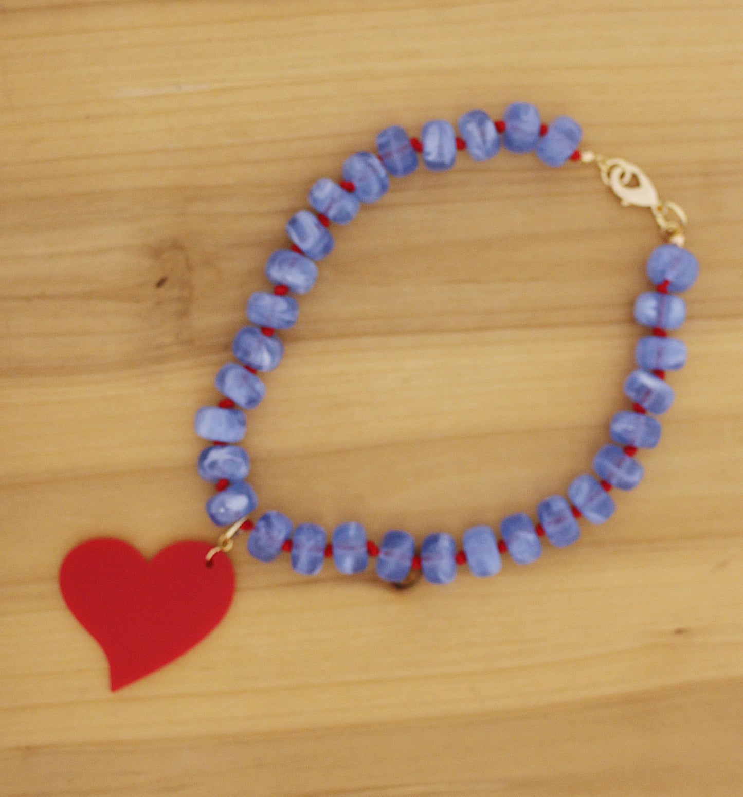 Blue donut shape beads with red heart charm necklace