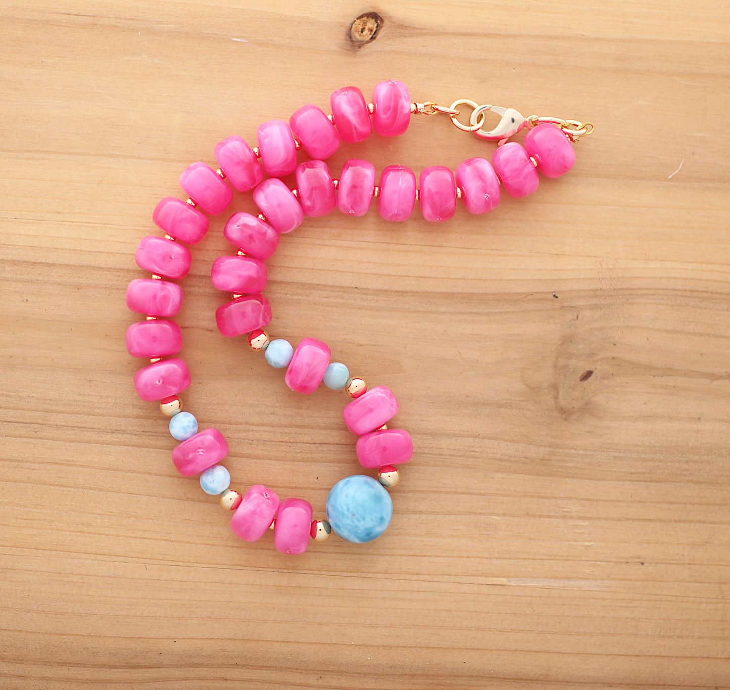Donut shape pink beads with a touch of Larimar necklace