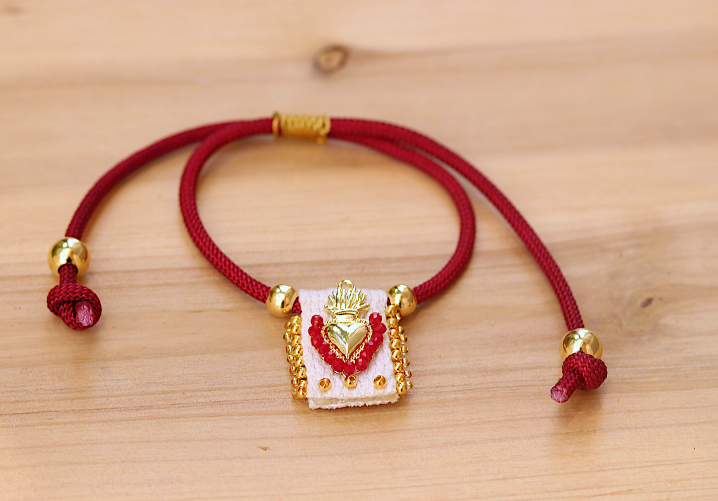 Scapular on red cord.