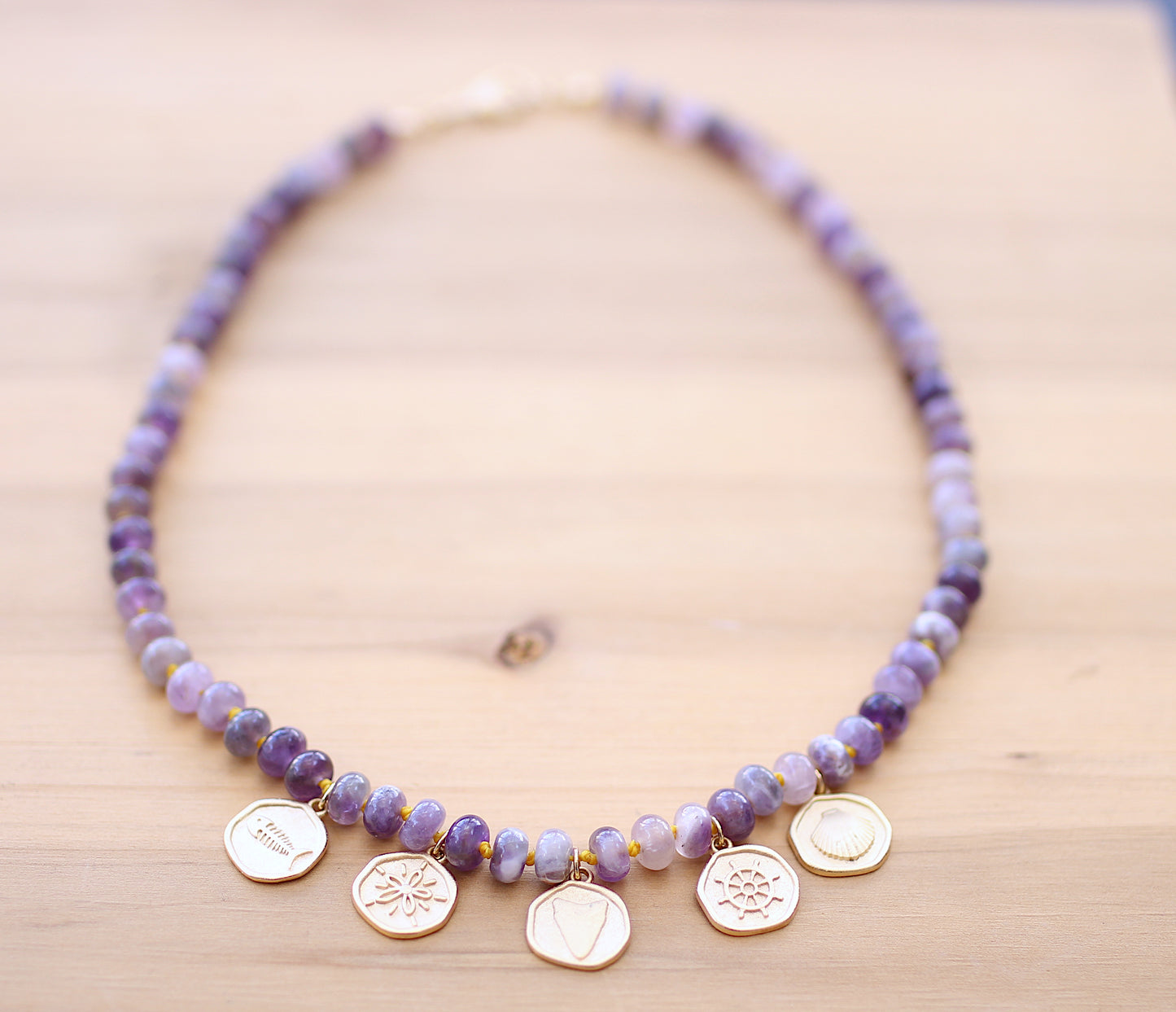 Purple necklace with sea motif round metals