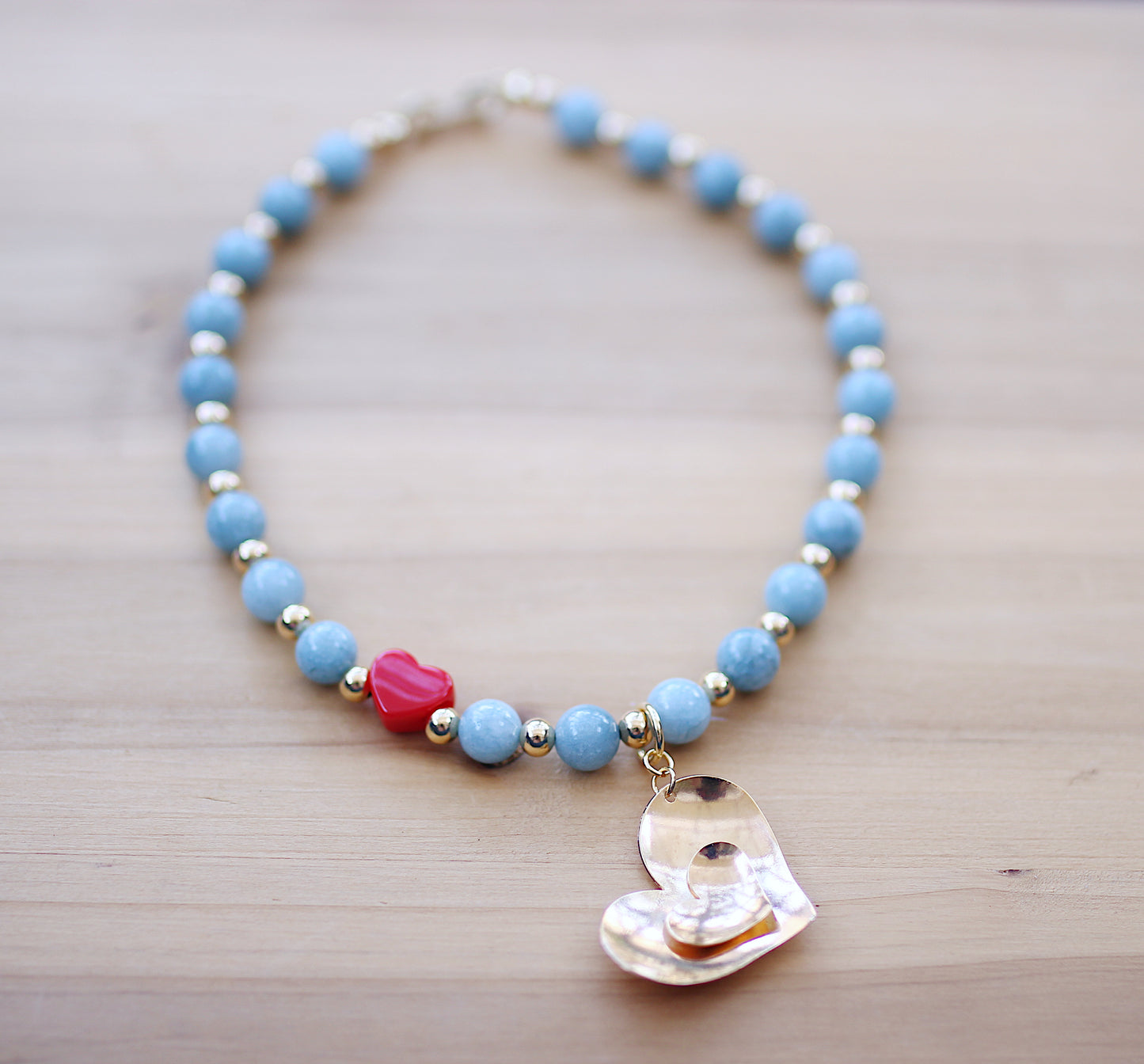 Blue aquamarine round beads with a heart charm