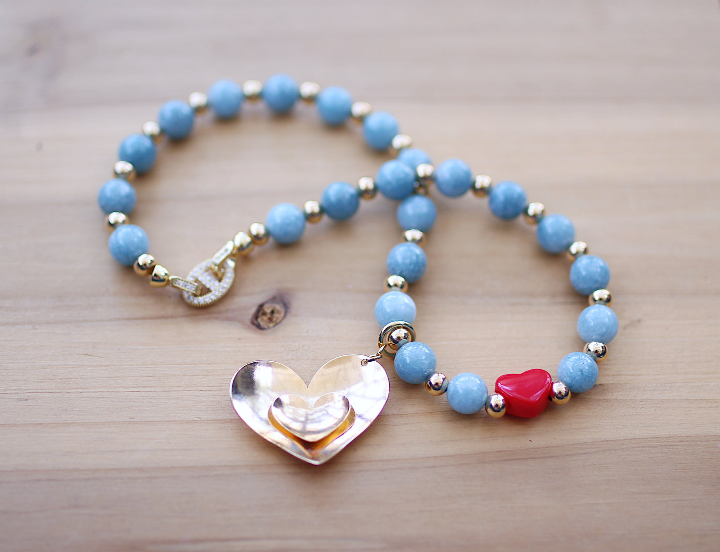 Blue aquamarine round beads with a heart charm