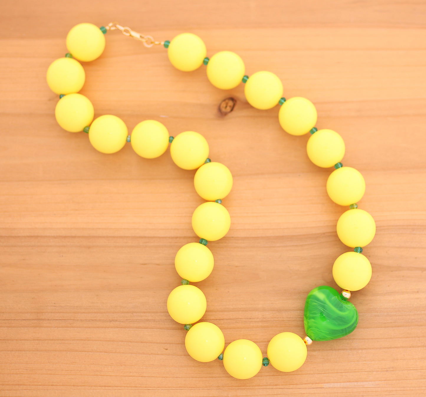 Yellow round beads necklace with green heart charm