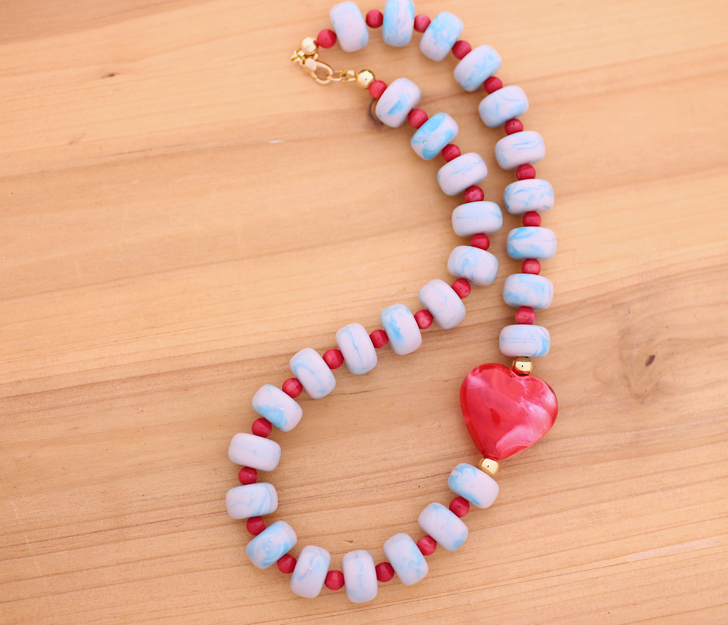 Blue marbleized donut shape beads with red heart necklace