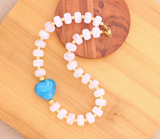 White marbleized donut shape necklace with blue heart