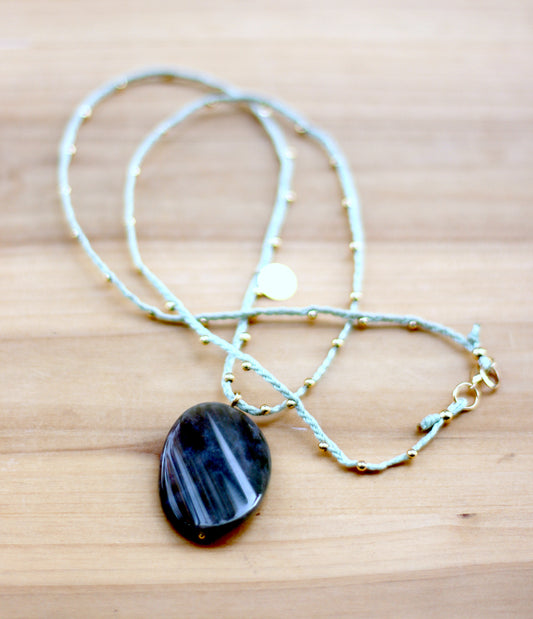 Green necklace with nephrite oval stone.