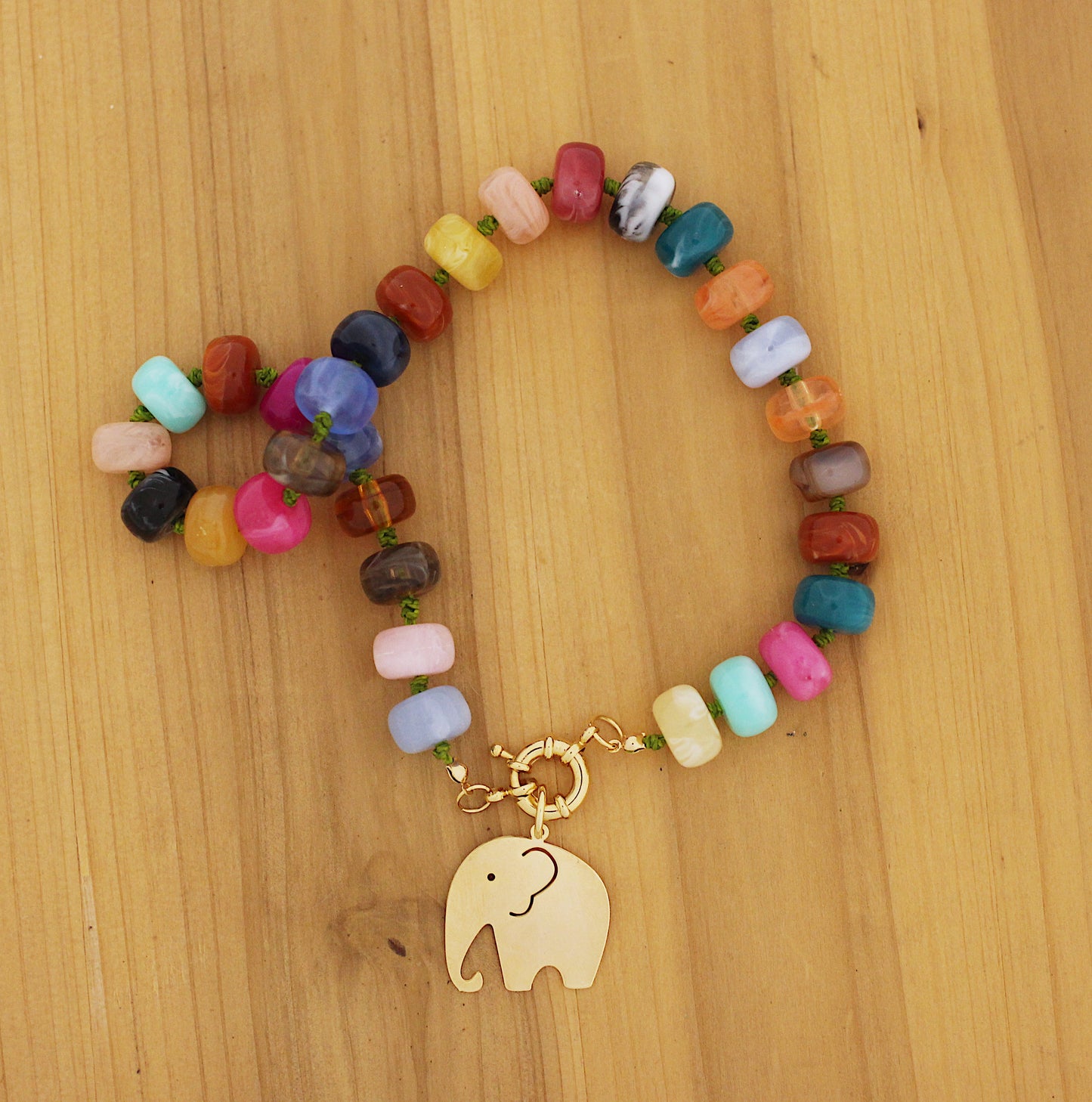 Multi color donut shape beads necklace with an elephant charm