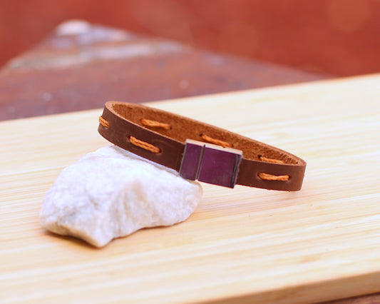 Leather bracelet with a yellow stitch line