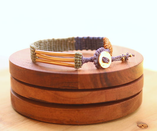 Green, blue and yellow macramé bracelet with a button clasp