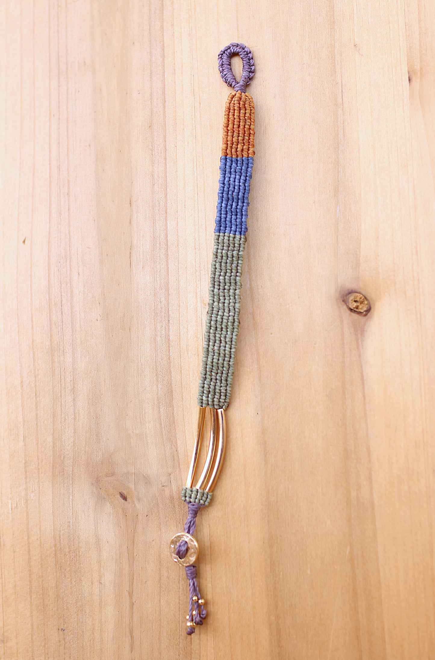 Green, blue and yellow macramé bracelet with a button clasp