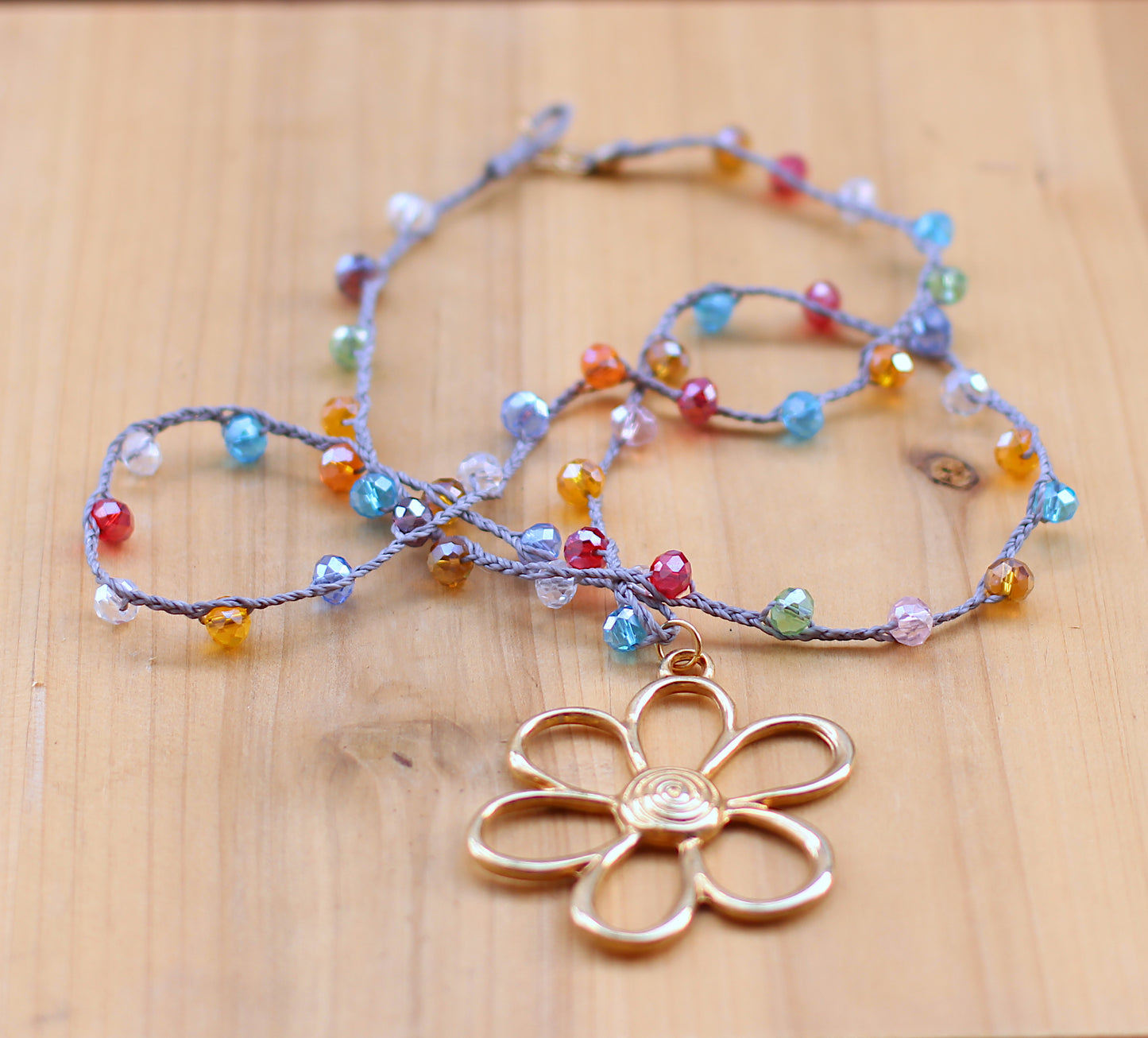 Multicolor beads necklace with a gold filled oversized flower