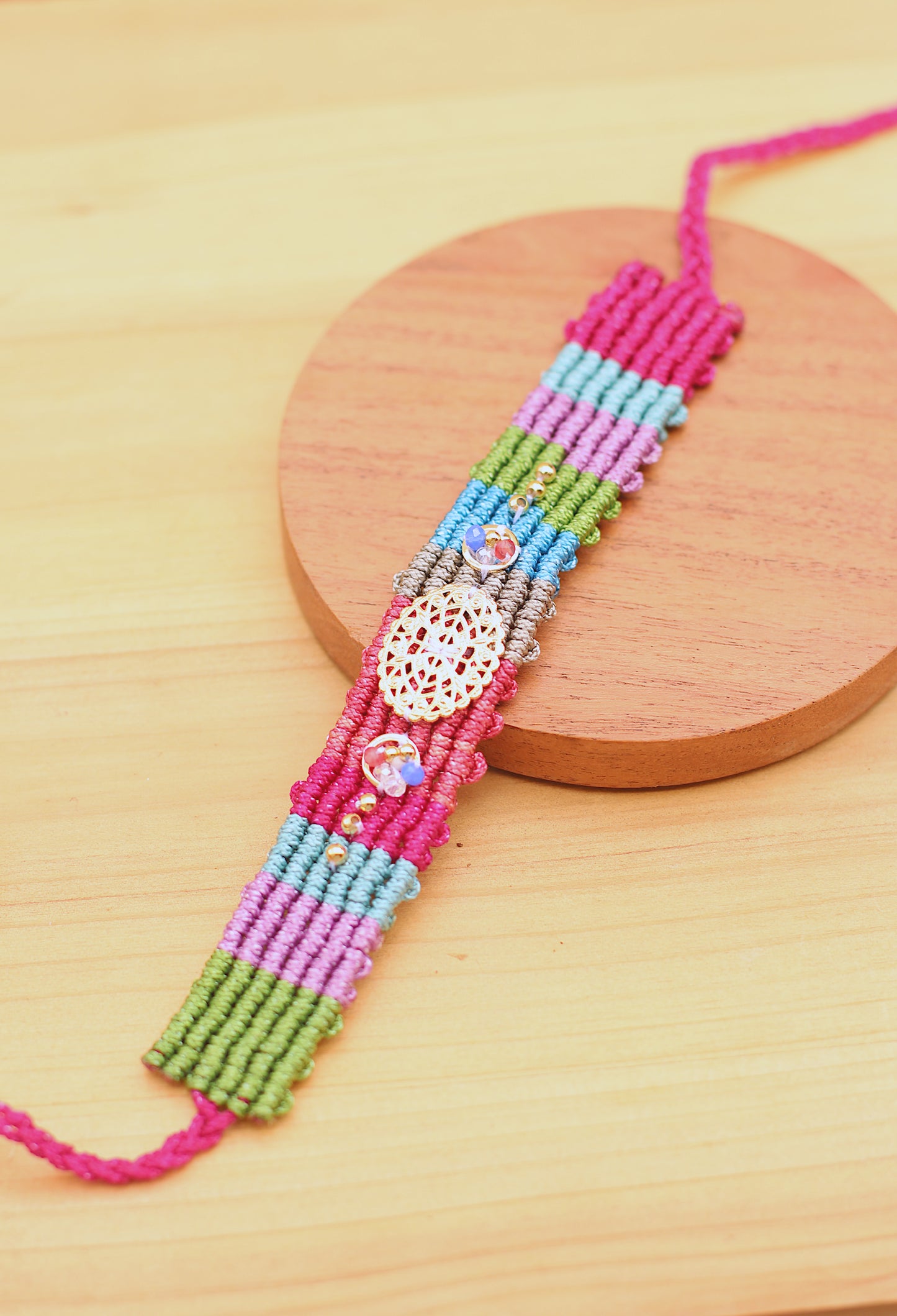 Wide multicolor bracelet with gold details.