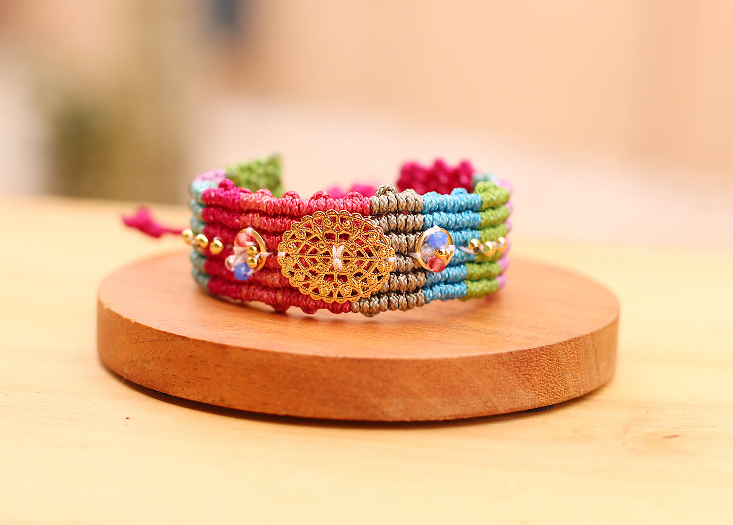 Wide multicolor bracelet with gold details.
